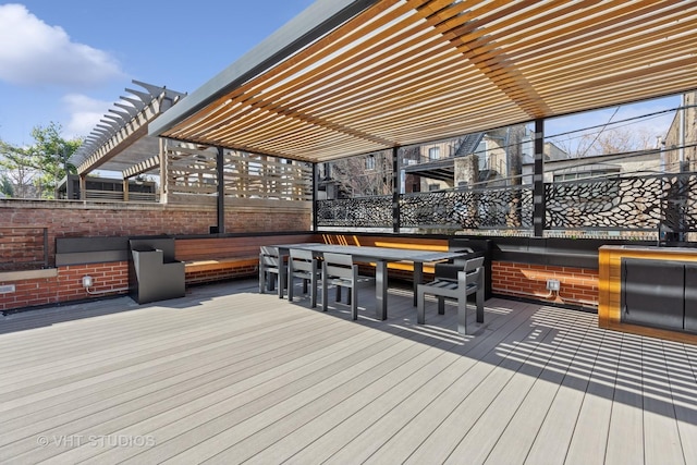deck featuring a pergola and outdoor dining space
