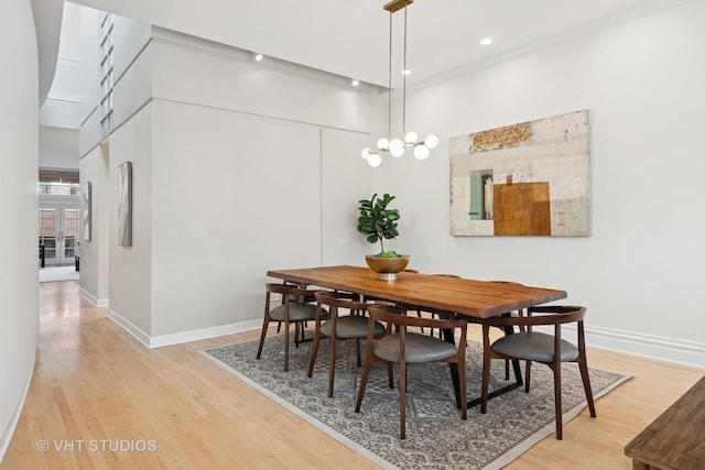 dining area with light wood finished floors, baseboards, and recessed lighting
