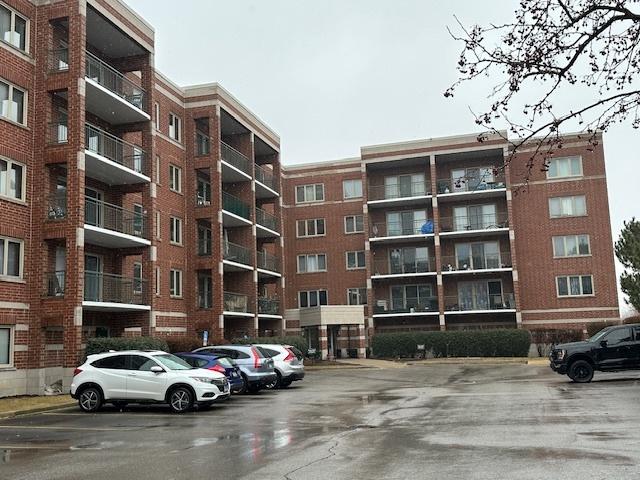 view of building exterior featuring uncovered parking