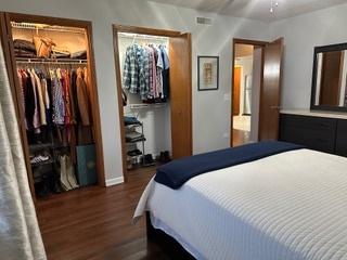 bedroom featuring dark wood finished floors and ceiling fan