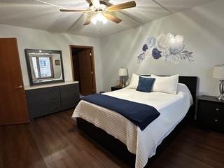 bedroom with dark wood finished floors and a ceiling fan