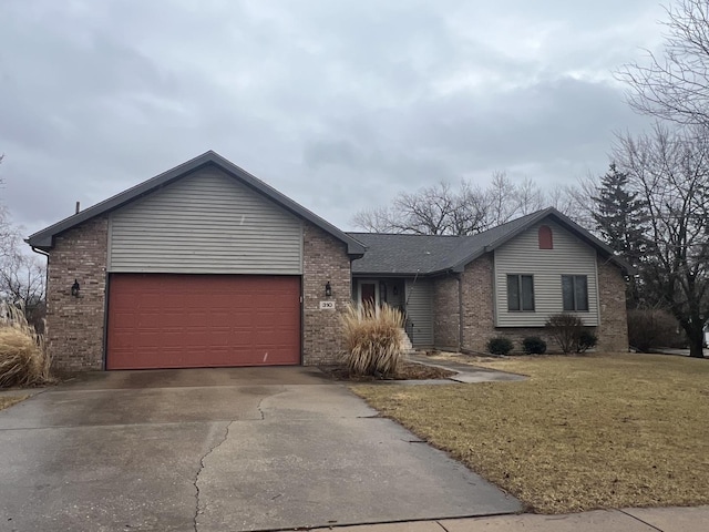 ranch-style house featuring an attached garage, brick siding, concrete driveway, roof with shingles, and a front yard