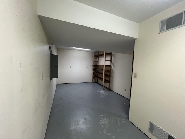 finished basement featuring electric panel and visible vents