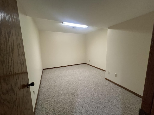 spare room with carpet and baseboards