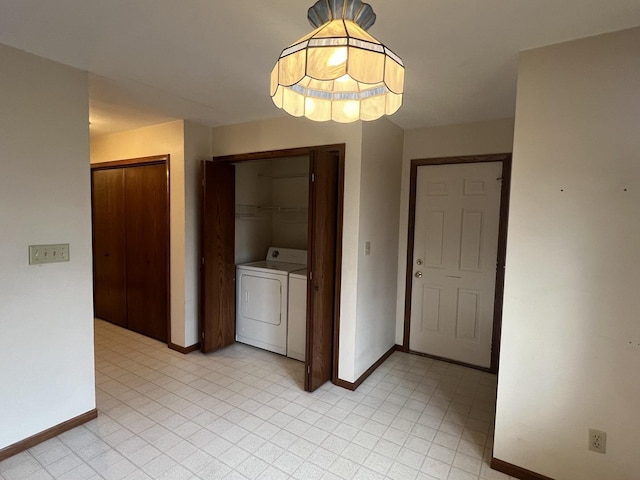 interior space with light floors, baseboards, and separate washer and dryer