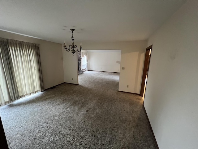 unfurnished dining area featuring carpet floors, a wealth of natural light, baseboards, and a notable chandelier