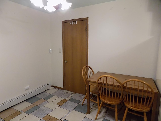 dining room with light floors and baseboard heating