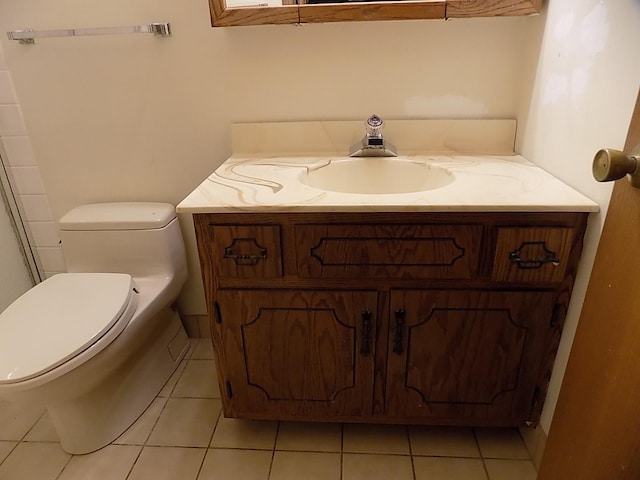 bathroom with toilet, tile patterned floors, and vanity