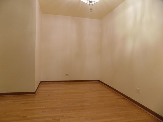 unfurnished room with light wood-style flooring and baseboards