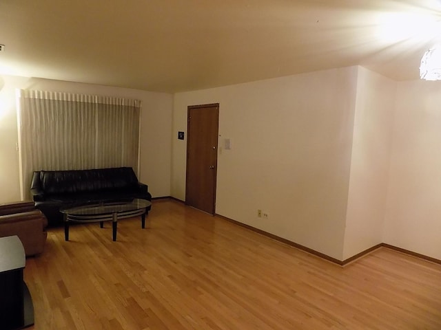 living area with light wood-style floors and baseboards