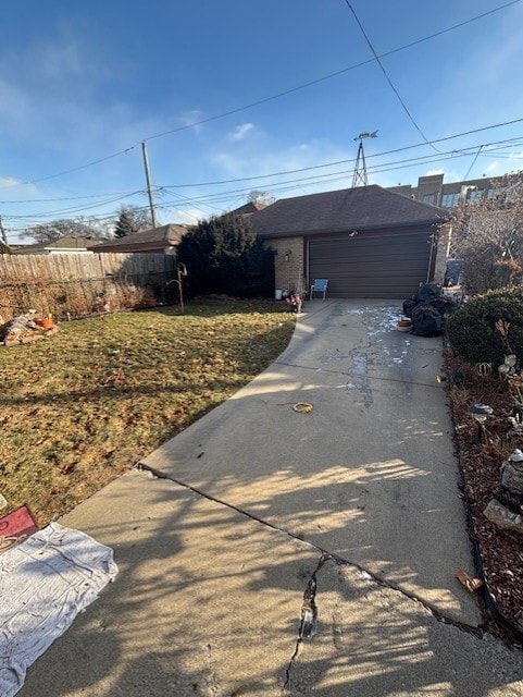 view of front of property with concrete driveway, brick siding, fence, and a front lawn