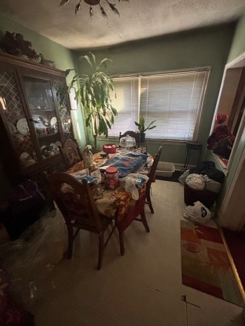 dining area featuring a textured ceiling