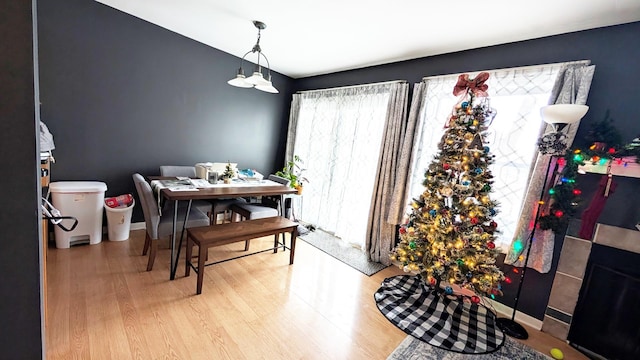 dining area with an inviting chandelier, wood finished floors, and baseboards