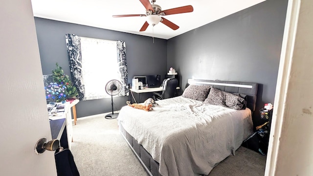 carpeted bedroom featuring ceiling fan and baseboards