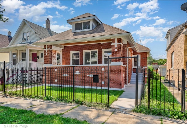 bungalow-style house with covered porch, brick siding, and a fenced front yard