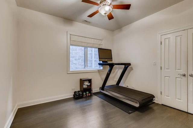 exercise area with ceiling fan, visible vents, baseboards, and wood finished floors