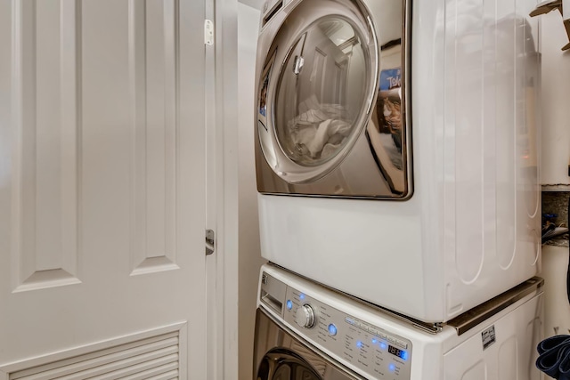 laundry room with stacked washer / drying machine