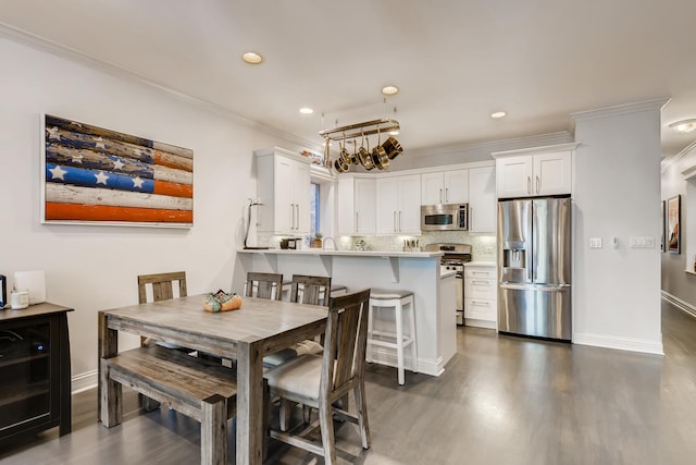 dining space featuring recessed lighting, baseboards, ornamental molding, and dark wood-style flooring