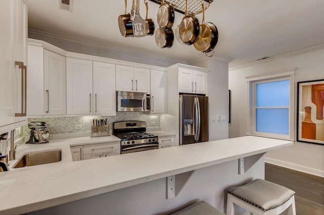 kitchen featuring visible vents, light countertops, ornamental molding, appliances with stainless steel finishes, and white cabinets