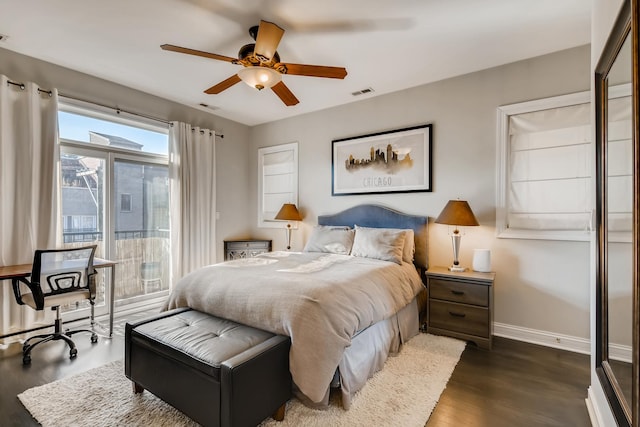 bedroom featuring visible vents, baseboards, dark wood-style floors, and access to outside