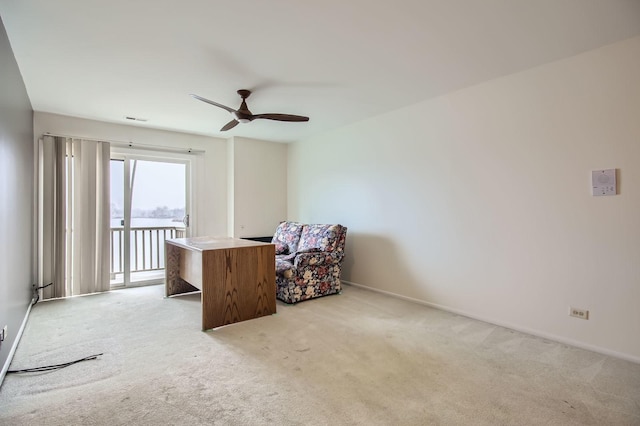 sitting room with baseboards, visible vents, a ceiling fan, and light colored carpet