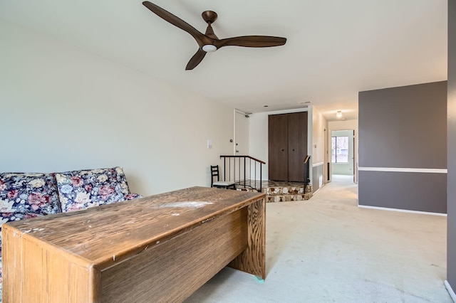 bedroom with a ceiling fan, light colored carpet, and baseboards