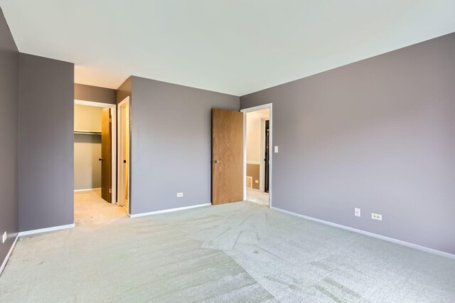 372 Springlake Ln Unit C, Aurora, IL 60504 - unfurnished bedroom featuring light colored carpet, baseboards, and a spacious closet