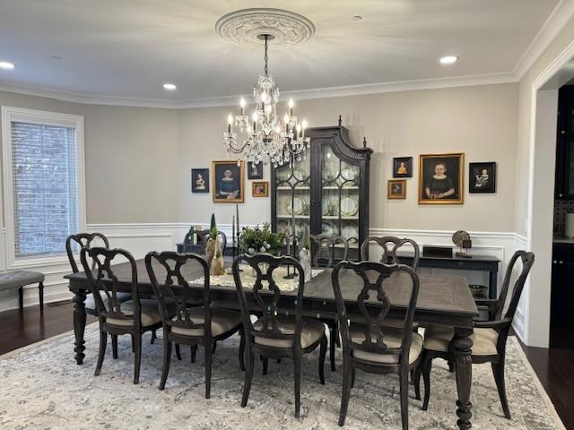 1860 Lake Charles Dr, Vernon Hills, IL 60061 - dining room with crown molding, a chandelier, wainscoting, wood finished floors, and a decorative wall