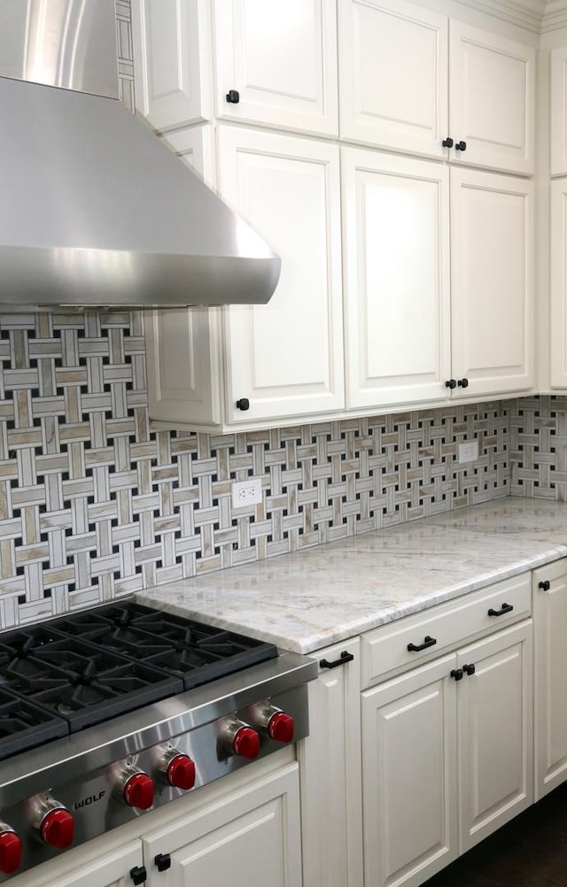 1860 Lake Charles Dr, Vernon Hills, IL 60061 - kitchen featuring wall chimney exhaust hood, stainless steel gas cooktop, decorative backsplash, and white cabinetry