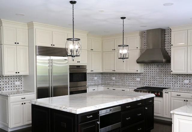 1860 Lake Charles Dr, Vernon Hills, IL 60061 - kitchen with appliances with stainless steel finishes, wall chimney exhaust hood, dark cabinetry, backsplash, and decorative light fixtures