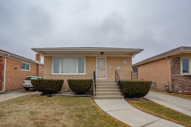 view of front facade featuring a front yard and brick siding