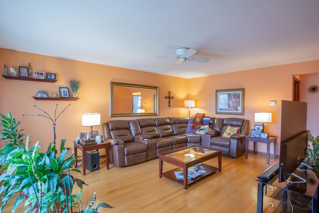 living room featuring light wood-style floors and a ceiling fan