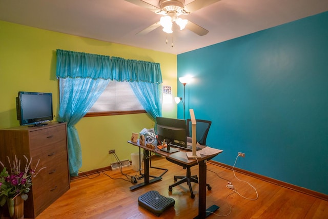 office space featuring ceiling fan, baseboards, and wood finished floors