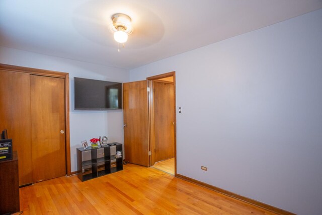 bedroom with light wood-style flooring and baseboards