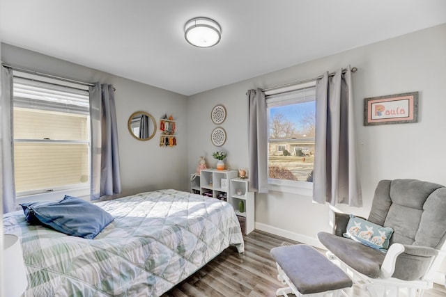 bedroom with wood finished floors and baseboards