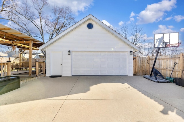 detached garage featuring fence