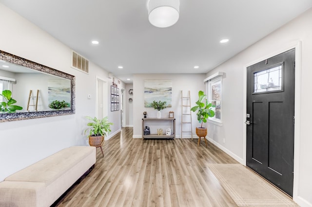 foyer entrance featuring visible vents, recessed lighting, baseboards, and wood finished floors