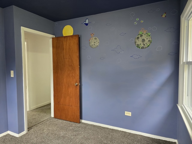 spare room with carpet flooring and baseboards