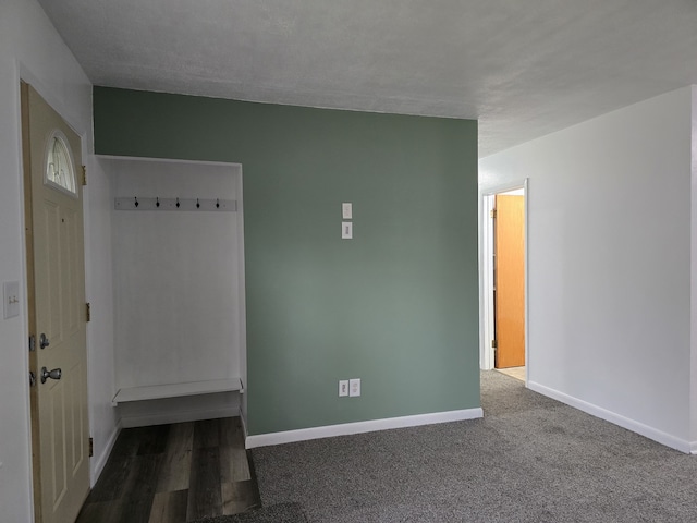 interior space with carpet and baseboards