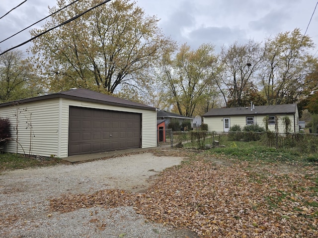 detached garage featuring fence