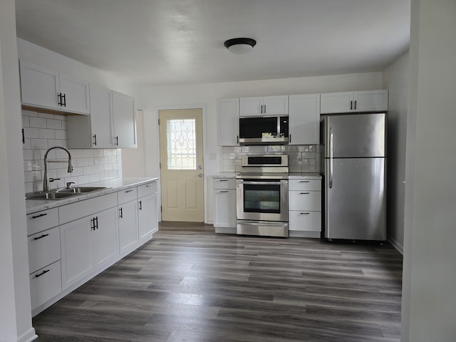 kitchen featuring white cabinets, dark wood-style flooring, stainless steel appliances, and a sink