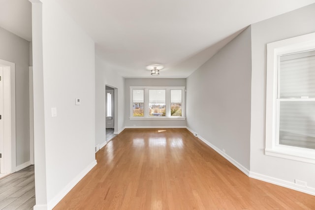 interior space featuring light wood-style flooring and baseboards