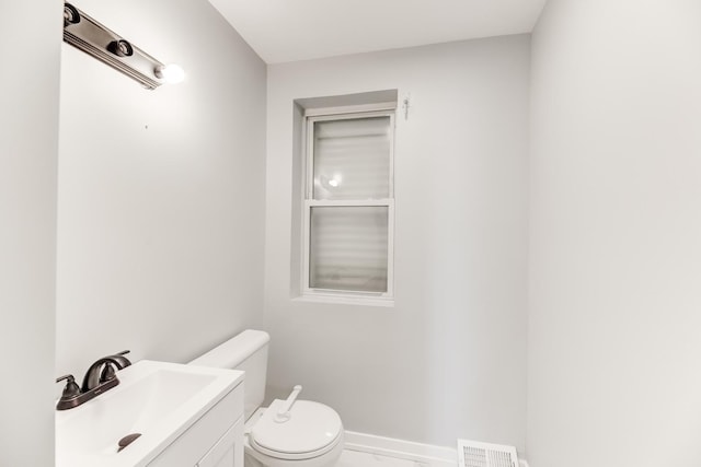 bathroom with visible vents, toilet, marble finish floor, baseboards, and vanity