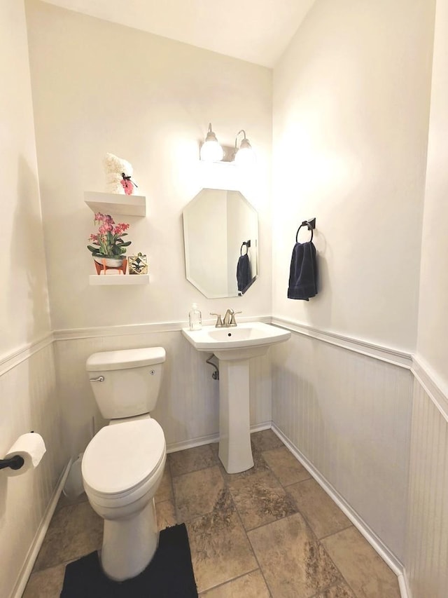 bathroom with wainscoting and toilet