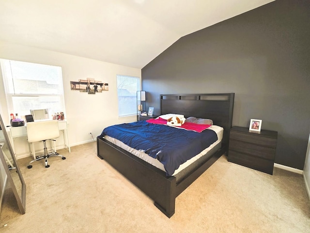 bedroom with baseboards, lofted ceiling, and carpet flooring