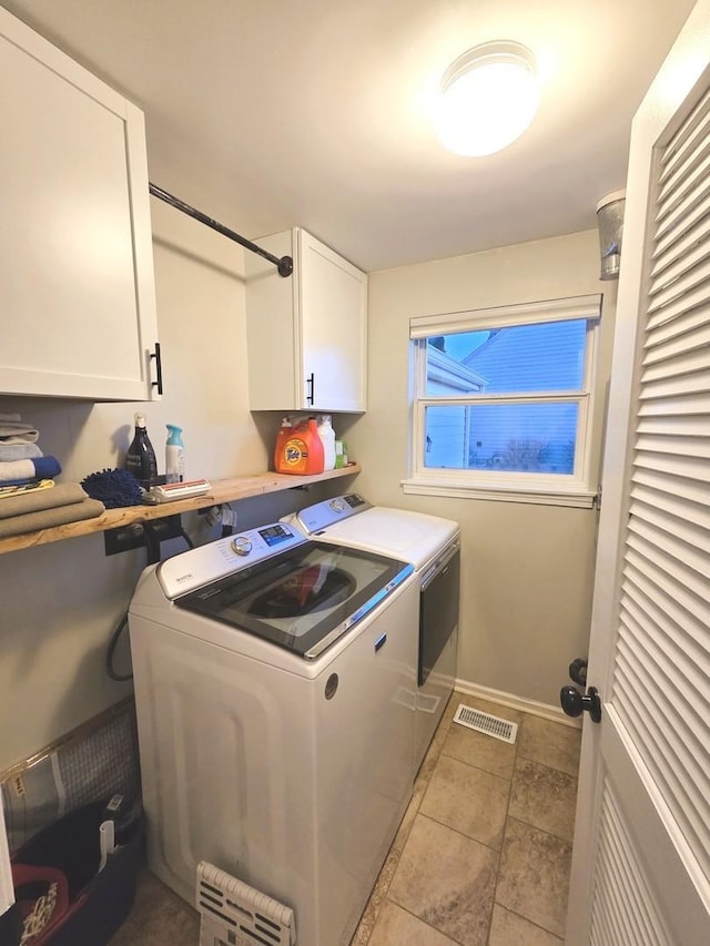 laundry area with washer and clothes dryer, visible vents, cabinet space, and baseboards