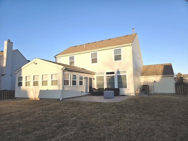 back of property with a patio area, a yard, and fence