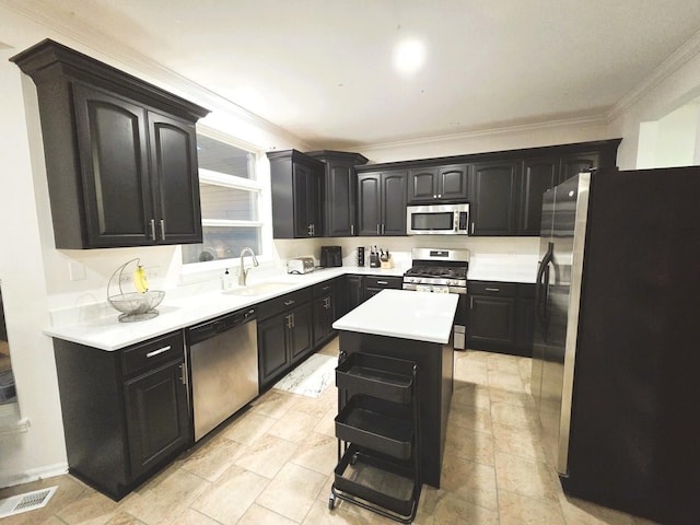 kitchen with visible vents, ornamental molding, a sink, stainless steel appliances, and light countertops