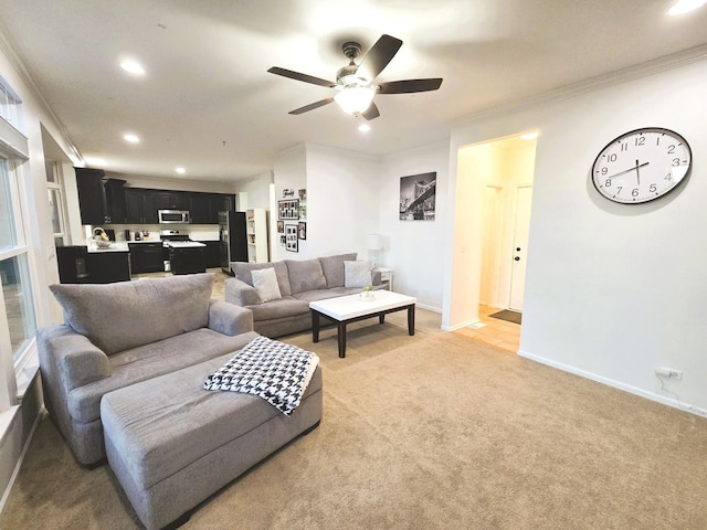 living area with baseboards, recessed lighting, ceiling fan, ornamental molding, and light colored carpet