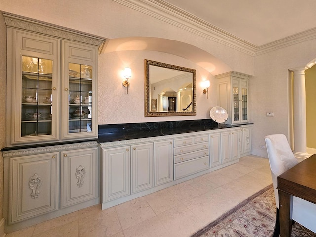 bathroom with decorative columns and crown molding